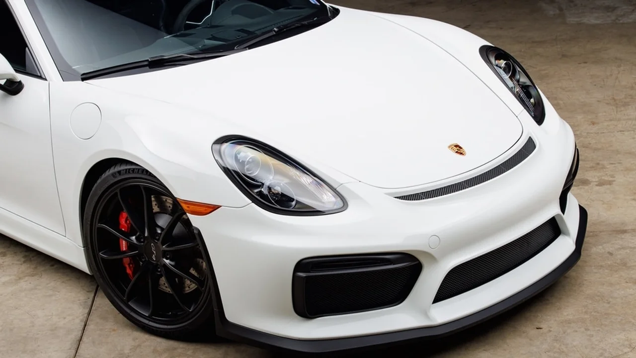 blue bowl of black bean beef tortilla soup on a board with cilantro and shredded cheese in background