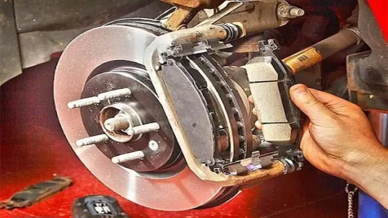 blue bowl of black bean beef tortilla soup on a board with cilantro and shredded cheese in background