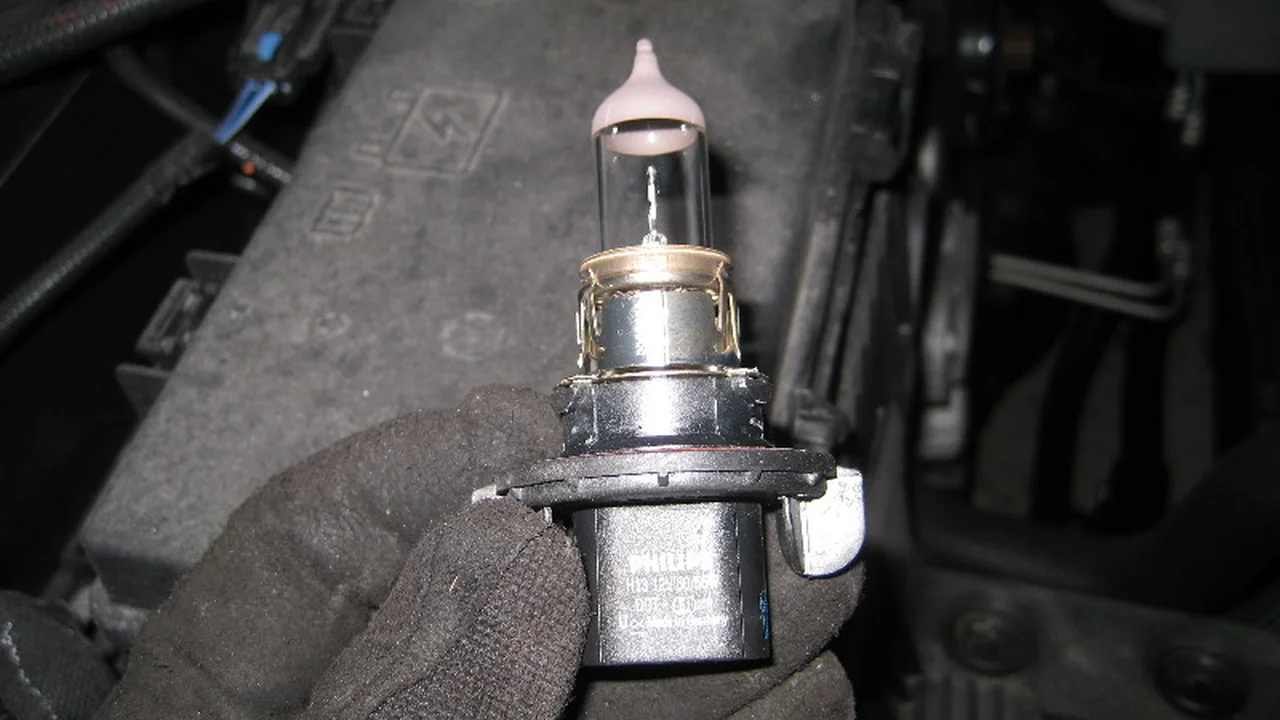 blue bowl of black bean beef tortilla soup on a board with cilantro and shredded cheese in background